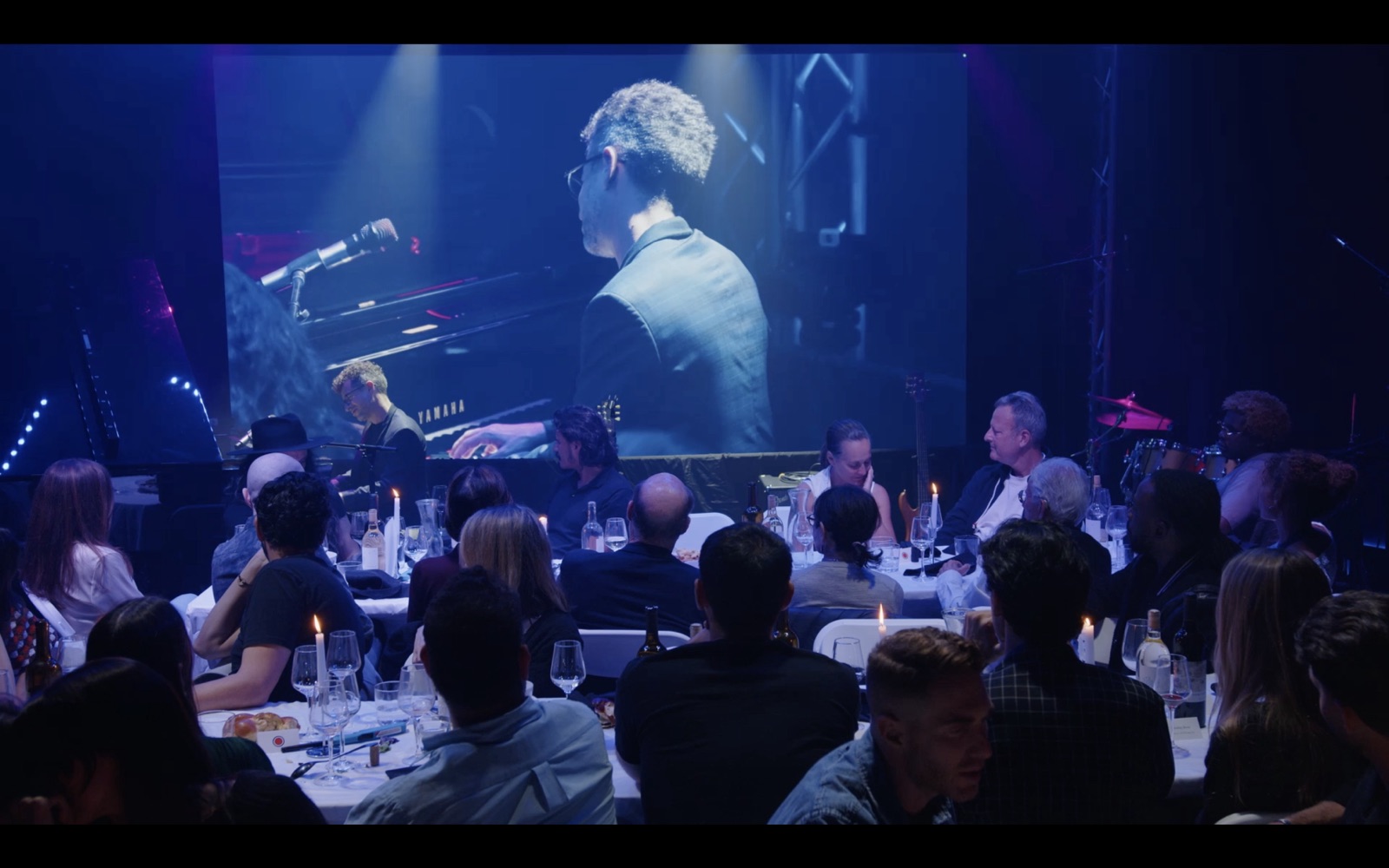 A member dinner in the Live Room, with someone playing the piano