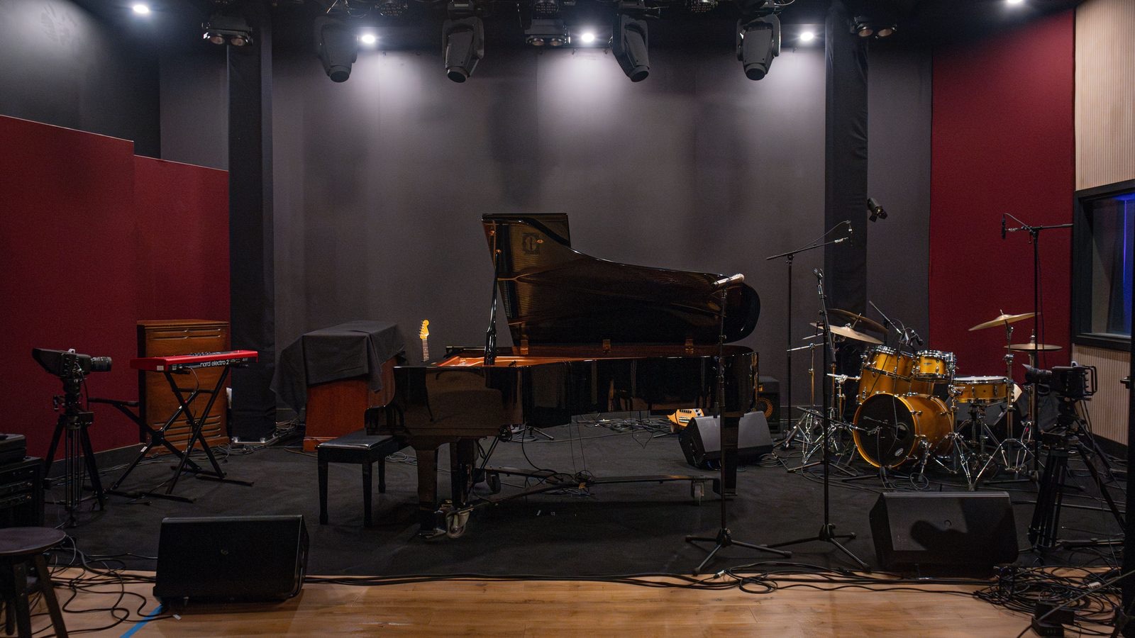 The Live Room at The Recording Club, set up for a session under warm stage lighting